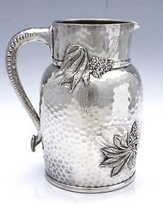 Tiffany hammered sterling water pitcher with chased sumac